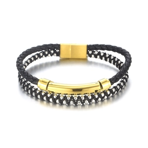 Black woven leather bracelet with silver beads and gold metal accents on white backdrop