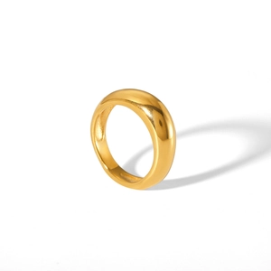 Close-up of a wide polished 18K gold stainless steel ring with a smooth curved surface