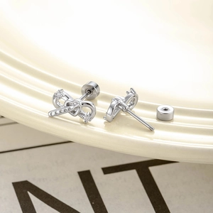 Silver bow and heart cartilage piercing studs with sparkling rhinestones and screw backs