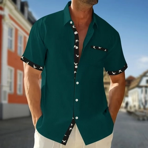 Men's dark green waffle knit short sleeve shirt with bird print details on outdoor street