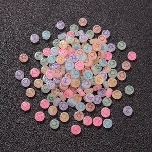 Close-up of assorted colorful luminous acrylic heart and star beads for DIY jewelry