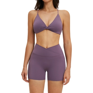 Two-piece purple yoga set with thin strap twist bra and crossover high waist shorts