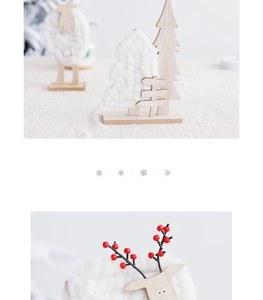 Detail of wooden Christmas tree and knitted reindeer ornaments with JOY and LOVE text