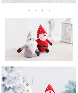 Handmade wool felt Santa and elf figurines in a cozy Nordic style Christmas tabletop scene