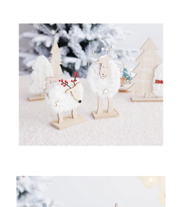 Close-up of wooden reindeer and wool felt Christmas trees on soft plush surface decor