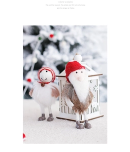 Detail of wool felt Christmas dolls with knit hats and bells in a cozy winter setting