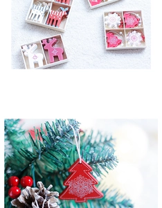 Close-up of red wooden Christmas tree ornament hanging on a festive pine branch