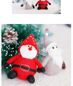 Close-up of handmade wool felt Santa and grey gnome ornaments with soft fiber texture