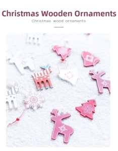 Close-up of wooden reindeer and snowflake ornaments with bells on white fur background