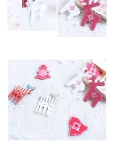 Macro detail of Nordic wooden Christmas tree ornaments with deer and bell designs