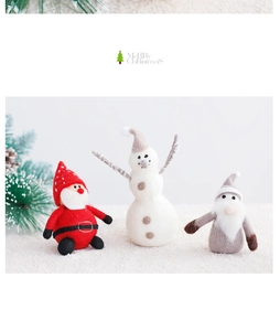 Close-up of handmade wool felt Santa, snowman and gnome Christmas ornaments on a desk