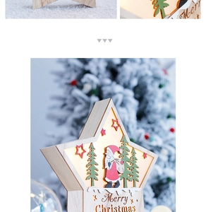 Macro view of wooden star LED light with Santa and pine scene for Christmas decor