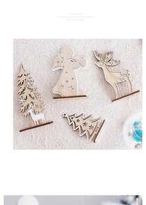 Top view of laser-cut wooden Christmas deer and tree ornaments on white plush fur