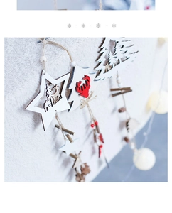 Detail of Nordic wooden Christmas star and deer ornaments on soft white faux fur background
