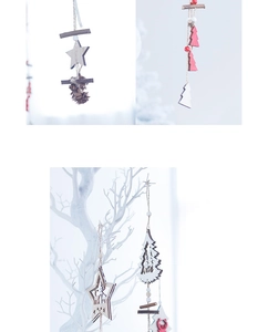 Detail of Nordic wooden Christmas star and reindeer ornaments hanging on a white branch