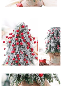 Close-up of frosted red berries and snow-flocked needles on a mini desktop Christmas tree