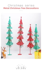 Macro shot of red and green iron Christmas trees with glitter finish and berry accents