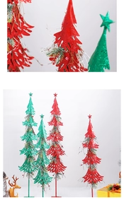 Detail of red and green glitter Christmas trees with faux berries and metal stands