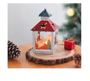 Detail of vintage Christmas iron lantern with Santa illustration and pine cone decor
