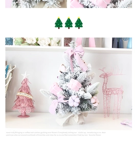 Close-up of pink mini Christmas tree with flocked snow, velvet bows and cotton balls