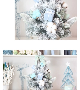 Close-up of mini flocked pink Christmas tree with light blue velvet bows and cotton balls