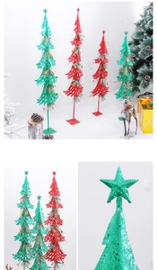 Close-up of red and green glittery Christmas tree silhouettes with star tree toppers