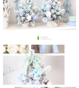 Close-up of pink mini Christmas tree with snow flocking, mint bows and blue gift boxes