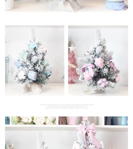 Close-up of mini pink and blue flocked Christmas trees with macaron bows and gift box decor