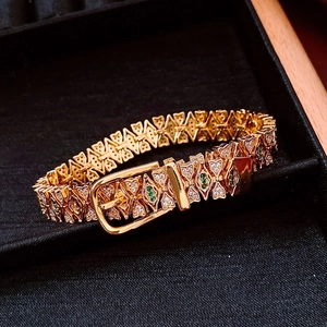 Detail of 18k gold plated bracelet with belt buckle design and green zircon stones