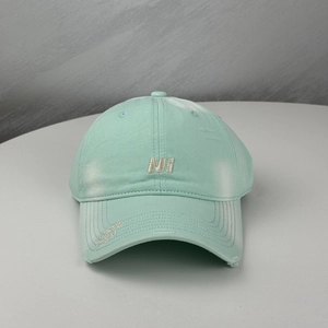 Detailed embroidery of Carpe Diem text and distressed rips on light mint baseball cap