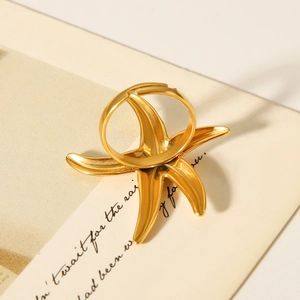 Detailed close-up of a golden starfish open ring with realistic ocean-inspired textures