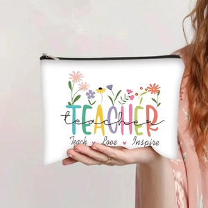 Close-up of Teacher canvas makeup bag with floral print and Teach Love Inspire slogan