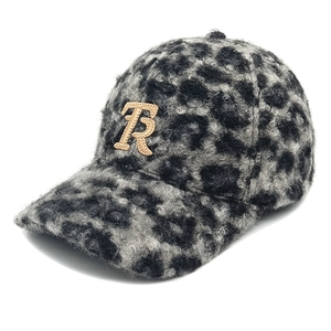 Close-up of leopard print faux fur baseball cap with golden embroidered R letter