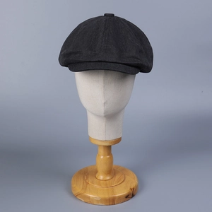 Classic retro newsboy cap in dark grey denim fabric displayed on a white head model