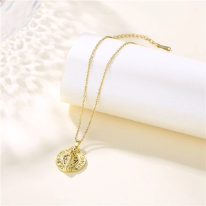 Golden cobra pendant necklace with sparkling colorful zircon on a white podium