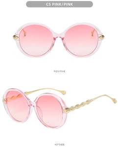 Detailed view of pink gradient round sunglasses with gold feather engraved temples