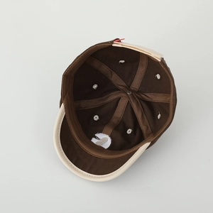 Interior detail of two-tone baseball cap with six-panel stitching and metal buckle
