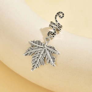 Silver retro coiled snake ear cuff with maple leaf pendant on a model ear