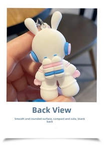Detailed back view of a cute space bunny astronaut keychain with smooth white silicone finish