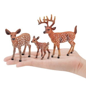 Three-piece set of realistic sika deer animal figurines held in hand for scale
