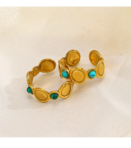 Bohemian gold plated rings with turquoise and malachite stones on fabric