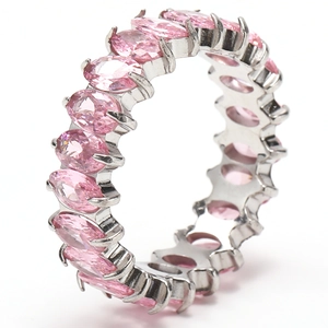 Macro shot of pink marquise-cut zircons set in a silver eternity band with claw setting