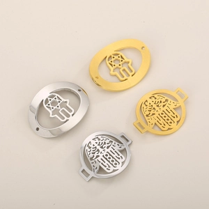 Detailed view of silver and gold Hamsa Hand charms for DIY jewelry bracelet making