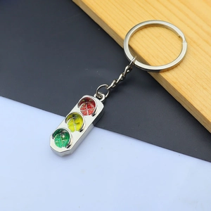 Close-up of traffic light keychain with sparkling red, yellow, and green glitter resin