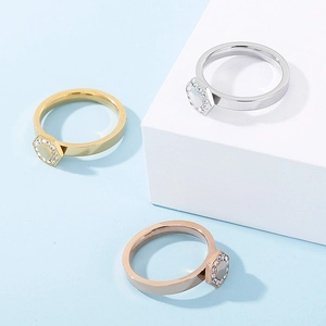 Close-up of hexagonal crystal pave rings in gold, silver and rose gold finishes
