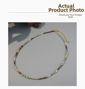 Close-up of bohemian beaded necklace with natural stones, gold beads and extender chain