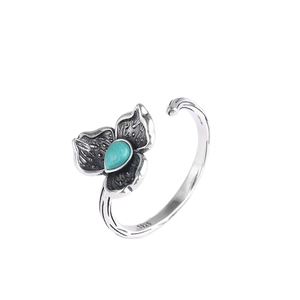 S925 sterling silver ring with flower design and turquoise stone on white background