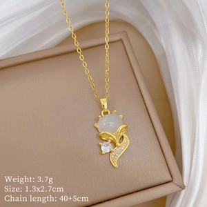 Macro view of gold fox necklace with cat eye stone and cubic zirconia detailing