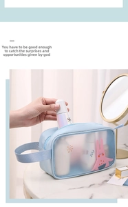 Detail view of a waterproof light blue cartoon PVC makeup bag with cute rabbit pattern