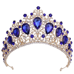 Close-up of golden crown with pear-shaped blue crystals and white rhinestones